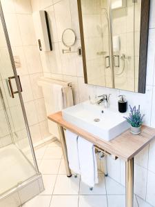 a bathroom with a sink and a shower at Hotel zur Loreley in Sankt Goar