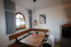 a dining room with a wooden table and a window at Alpenflair Ferienwohnung 232 Talstation in Oberstdorf