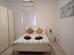 a bedroom with a bed with two pillows on it at University Area Msida in Msida