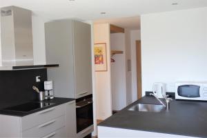 Küche/Küchenzeile in der Unterkunft Greppons MOUNTAIN & RESTFUL apartments by Alpvision Résidences