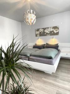 a bedroom with a bed and a potted plant at Am Weinberg - stilvoll, ruhig, zum wohlfühlen in Pfaffenweiler
