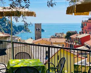 a table and chairs on a balcony with a view of a city at Albergo Degli Amici in Monterosso al Mare +37 photos