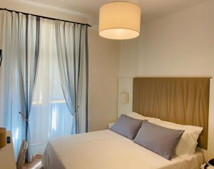 a bedroom with a bed and a large window at Albergo Degli Amici in Monterosso al Mare