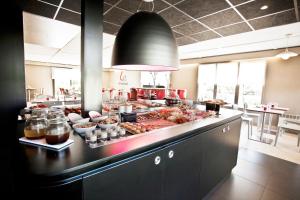 a kitchen with a buffet of food on a counter at Campanile Bourges Nord - Saint-Doulchard in Bourges