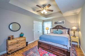 a bedroom with a bed and a ceiling fan at Pet-Friendly Brownsville Retreat with Porch! in Sloans Crossing
