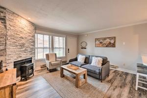 a living room with a couch and a fireplace at Chic Eden Condo with Pool Access Less Than 5 Mi to Ski! in Eden