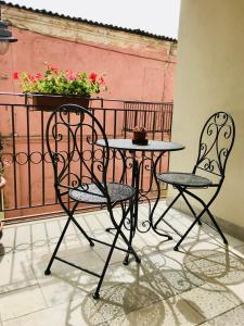 a table and two chairs on a balcony at Almasarda in Olbia