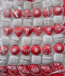 a group of red and white cookies with hearts at Almasarda in Olbia