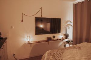 a bedroom with a bed and a television on the wall at Studio tt confort coeur ville avec terrasse et parking gratuit in Sanary-sur-Mer +22 photos