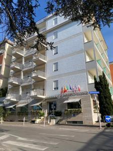 a building with flags in front of a street at Hotel La Meridiana in Sorrento