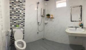 a bathroom with a shower and a toilet and a sink at The Best House&Hostel in Ban Don Muang