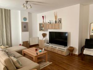 a living room with a large flat screen tv at Green Pipera 1 in Voluntari