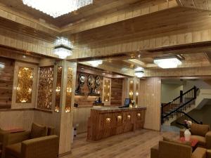 a lobby with a staircase and a desk and chairs at Hotel Zingkham Residency in Gangtok