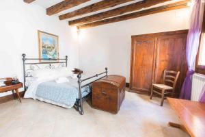 a bedroom with a bed and a wooden cabinet at CANAL DREAM cosy apartment with canal view in Venice