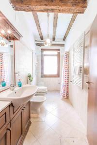a bathroom with a sink and a toilet at CANAL DREAM cosy apartment with canal view in Venice