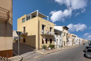 a building on the side of a street at B&B A casa di Aurora rooms in San Vito lo Capo