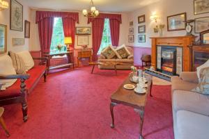 a living room filled with furniture and a fireplace at Tankerville Arms Hotel in Wooler