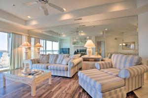 a living room with two couches and a table at Lake Ozark Condo with Balcony and Water Views! in Lake Ozark
