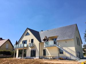 a house under construction with a gray roof at Ferienwohnungen Familie Mapenzi in Waischenfeld
