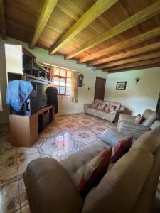 a living room with a couch and a tv at Lodge Acopampa Inn in Carhuaz