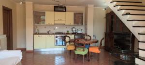 a kitchen with a table and chairs in a room at Olivo Al Mare - by Host4U in Dolcedo