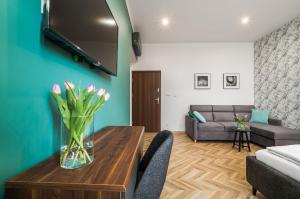 a living room with a vase of flowers on a table at EASY RENT Piłsudskiego 6 in Przemyśl