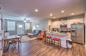 a kitchen and living room with a stainless steel refrigerator at Updated Apt 1 Mi to Western Kentucky University! in Bowling Green