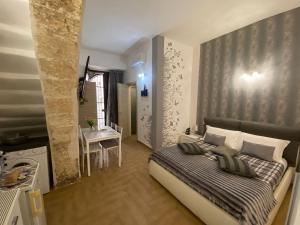 A bed or beds in a room at Residence Emozioni Ortigia