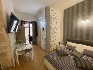 A bed or beds in a room at Residence Emozioni Ortigia