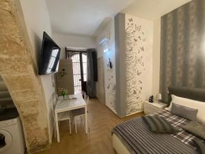 A bed or beds in a room at Residence Emozioni Ortigia