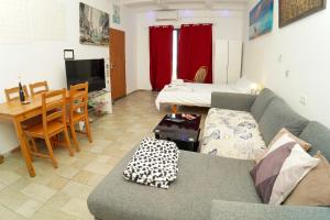 a living room with a couch and a table at comft suite Nahariyya in Nahariyya