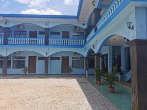 a building with a blue and white facade at Hotel y Restaurante El Marino in Santa Cruz