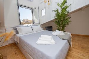 a bedroom with a bed with white towels on it at Casa Flora in Corfu Town