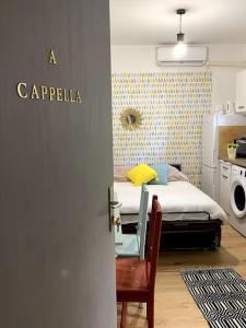 a small bedroom with a bed and a chair at studio cappella in Ajaccio