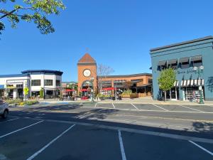 an empty street in a town with a clock tower at Sun Valley Inn in Pleasant Hill