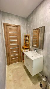 a bathroom with a white sink and a mirror at Sycamore Retreat Fundata in Fundata