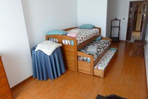 two bunk beds in a room with a wooden floor at Be Local - Apartment with 2 bedrooms in Infantado in Loures in Loures