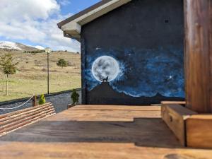 a mural of the moon on the side of a building at Rifugio Silone in Pescina