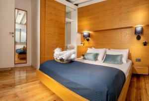 a bedroom with a large bed with a wooden headboard at Kumbaracı Apartments & Suites in Istanbul