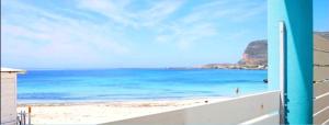 a view of the beach from the balcony of a building at Stabilimento Lido Burrone in Favignana
