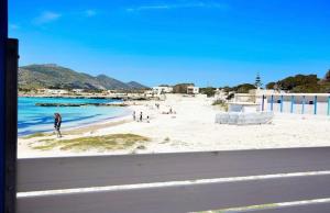 a view of a beach with people on the sand at Stabilimento Lido Burrone in Favignana