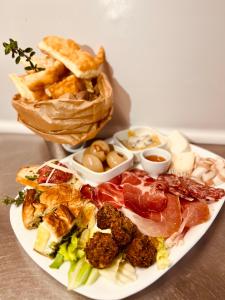 a plate of food with meat and other foods at Agriturismo La Betulla in Brezzo