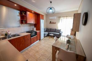 a kitchen and living room with a table and a couch at Filanthis inn in Kalamata