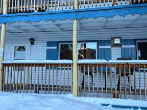 a blue house with snow on the porch at Mountain View Lodge in Red River