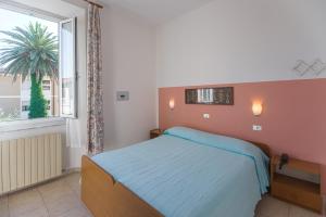Postel nebo postele na pokoji v ubytování Hotel Fiammetta