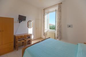 Cama ou camas em um quarto em Hotel Fiammetta