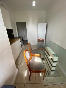 a kitchen with a table and a chair and a desk at Homefort in Düsseldorf