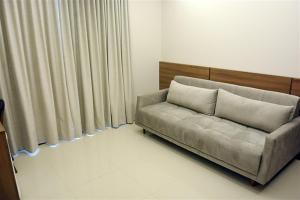 a couch sitting in a living room next to a curtain at Pituba Praiamar Hotel in Salvador +27 photos