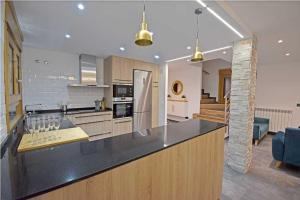 a kitchen with a black counter top in a room at Casa Rural La Cueva del Agua in Fuentetoba