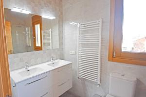 a bathroom with a sink and a toilet and a mirror at Casa Rural La Cueva del Agua in Fuentetoba